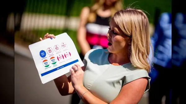 Karoline Leavitt with pale hands and a tan body