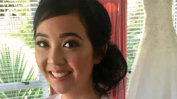 Woman smiling with side bun 