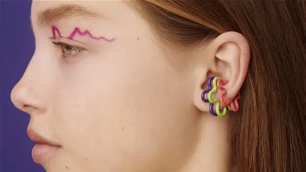 Woman wearing flower ear cuffs