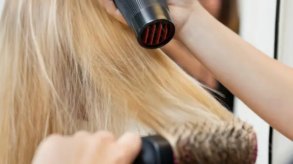 Woman having her hair blowdried