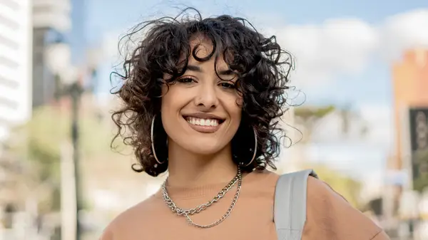 Woman with a curly wolf cut