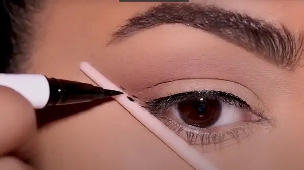 Artist applying liner 
