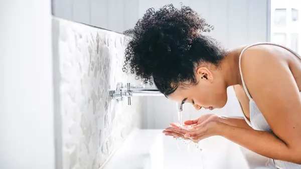 Woman washing her face