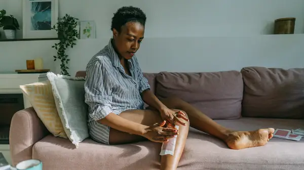Woman waxing her legs