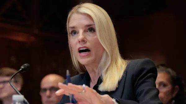 Pam Bondi speaking into a microphone