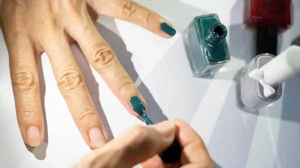 person painting their nails