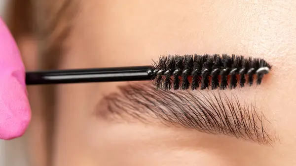 Makeup artist brushing client