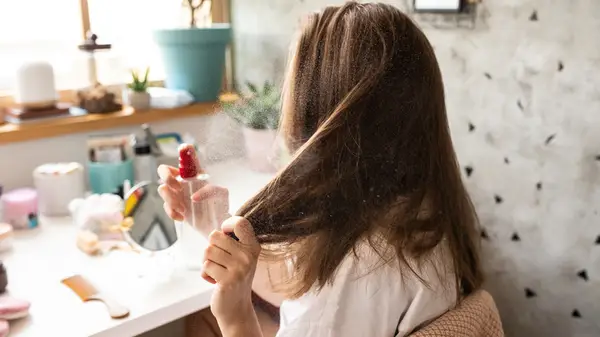 woman spraying hair