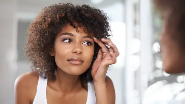 Woman touching her eyebrow