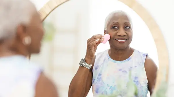 woman touching up foundation 