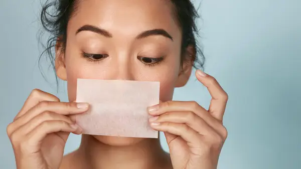 A woman blotting her face