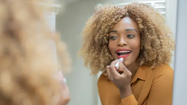 Woman applying lipstick