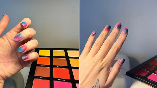 Nails with pink and blue manicure and an eyeshadow palette