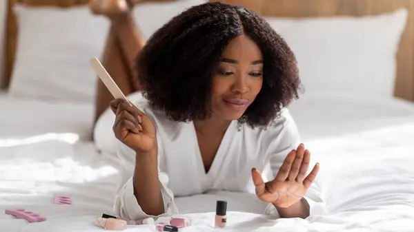 Woman doing her own manicure