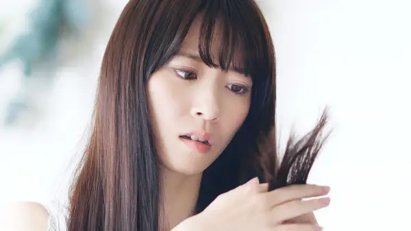 Woman looking at split ends