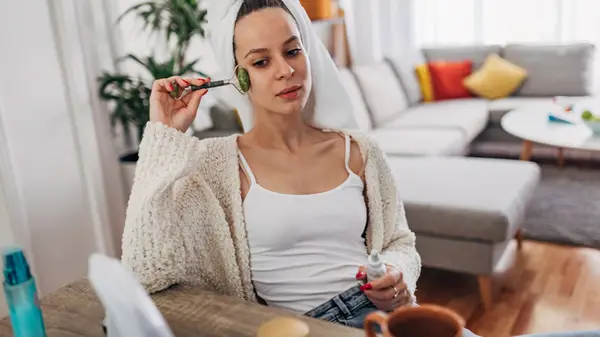 woman using face roller