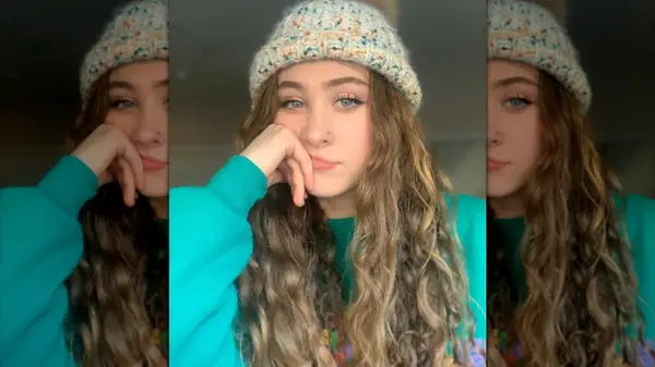 A selfie of Chappell Roan with curly brown hair and a knitted cap