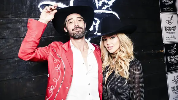 Ryan Bingham and Hassie Harrison wearing cowboy hats