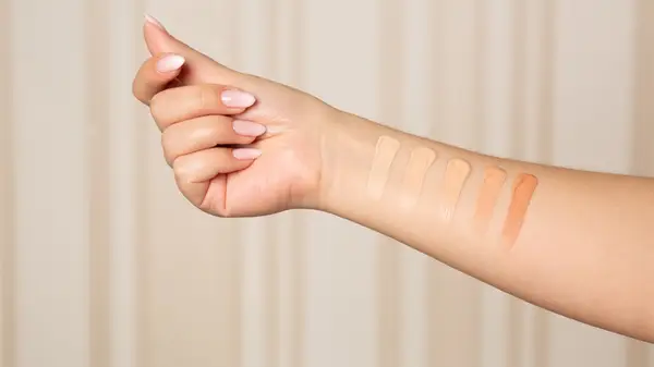 Womens arm with swipes of makeup shades