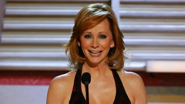 Reba McEntire speaking into a microphone