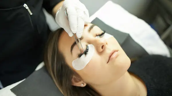 Woman getting lash extensions put in 
