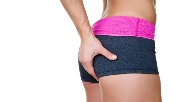 A person touching their butt