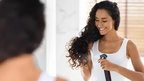 woman spraying hair detangling