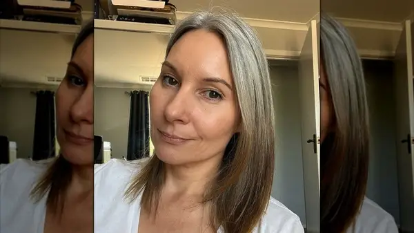 A woman with shoulder-length hair with face-framing layers