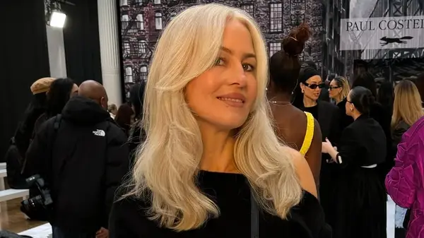 A woman with a medium-length cut and curtain bangs