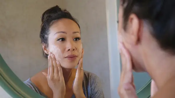 woman cleansing face