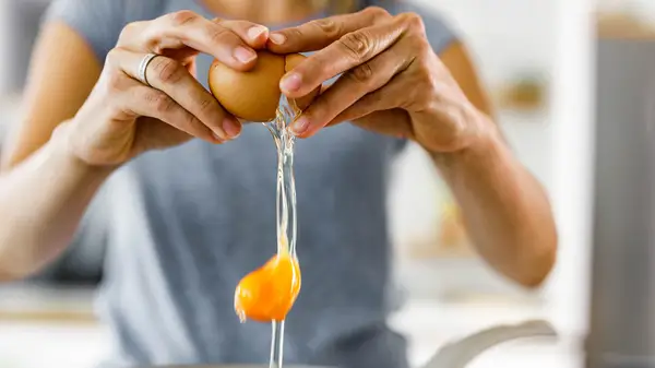 woman cracking egg