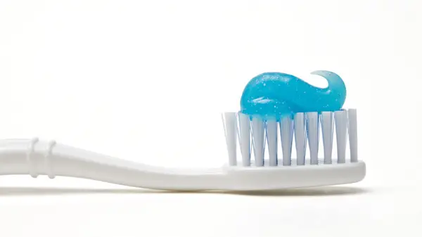toothpaste on toothbrush