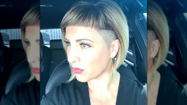 A selfie of a blonde woman with a shaved undercut bob