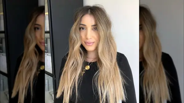 A woman with long blonde hair of all one length