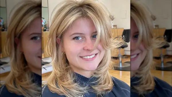 A blonde woman with short, flippy layers