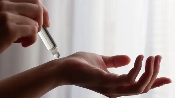 Applying perfume oil 