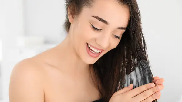 Woman conditioning her hair