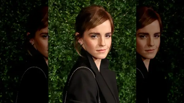 Emma Watson in front of a hedge