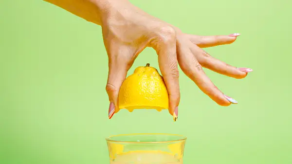 hand squeezing lemon