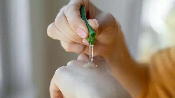 hand squeezing out aloe vera 