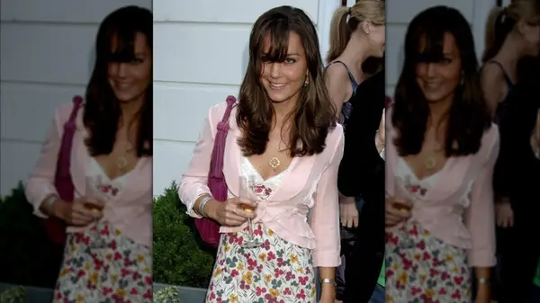 Kate Middleton at an event with super long bangs in her face and a pink blazer