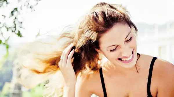 Woman long curly brown hair smiling