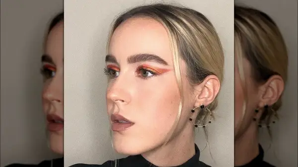 A woman wearing orange eyeliner 