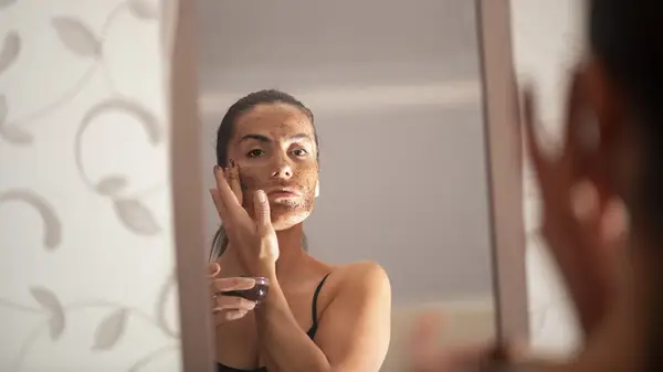 Woman exfoliating her skin