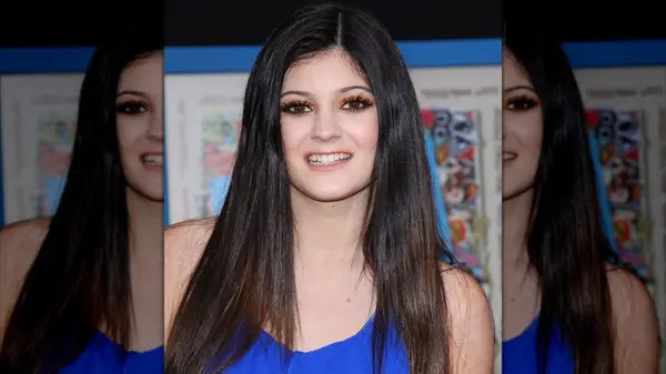 Kylie Jenner wearing orange eyeshadow and a blue dress
