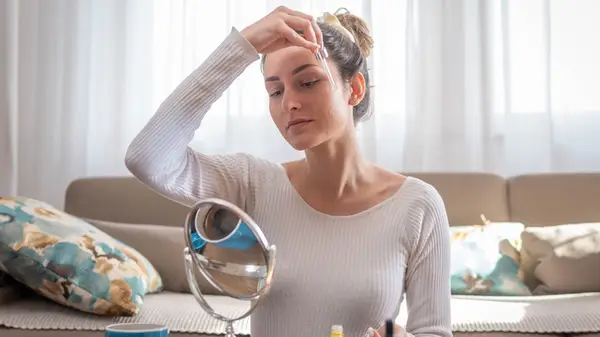 Woman applying skincare