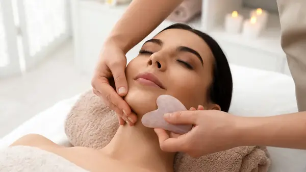 Woman receiving gua sha treatment