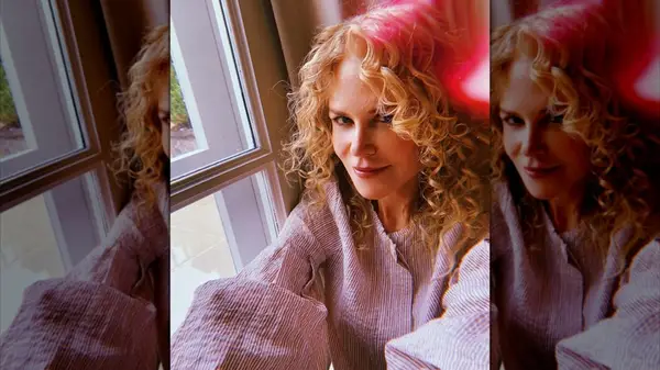 Selfie of Nicole Kidman smiling with middle-parted, curly hair