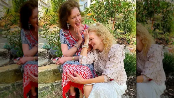Nicole Kidman with curly hair laughing while leaning on her mother