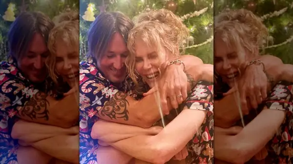 Keith Urban and Nicole Kidman in a side embrace while Kidman wears a wavy updo